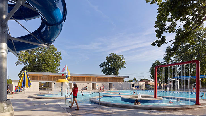 Fair Grounds Aquatic Park's outdoor leisure pool with a lazy river, water umbrella and spray arch